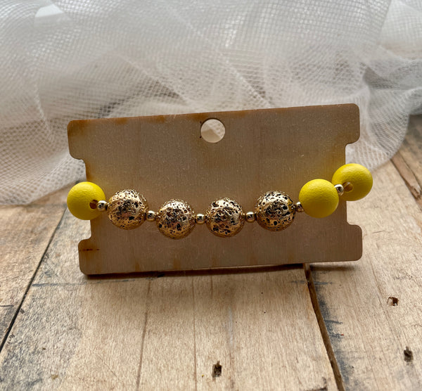 yellow metal & wood bead stretch bracelet