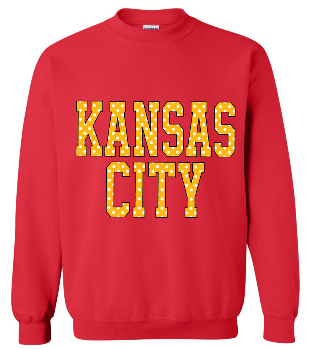 A red crewneck sweatshirt featuring the words 'KANSAS CITY' printed across the chest in yellow varsity-style letters with a white polka-dot fill pattern.